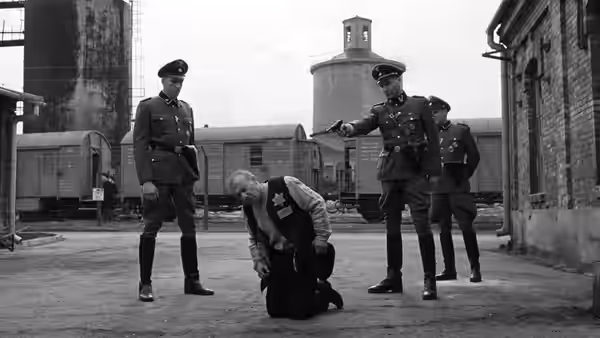 Officer aiming a pistol at a kneeling man wearing a Star of David vest