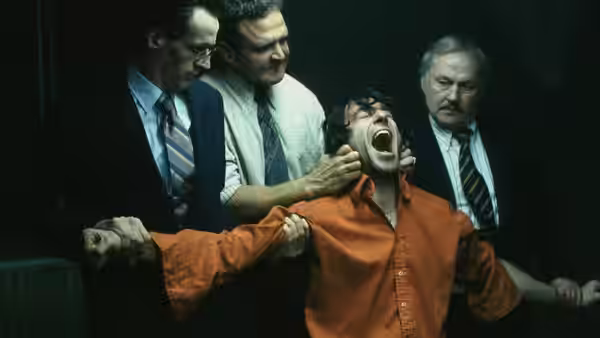 Gerry Conlon (Daniel Day-Lewis) restrained by officers while shouting