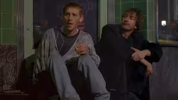 Archie (Ewen Bremner) and Johnny (David Thewlis) sitting on steps at night