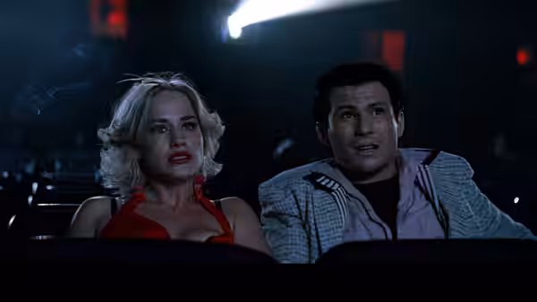 Alabama Whitman (Patricia Arquette) sits beside Clarence Worley (Christian Slater) in a movie theater