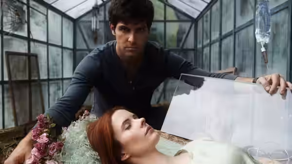 Nick Burkhardt (David Giuntoli) leans over Juliette Silverton (Elizabeth Tulloch) in a greenhouse