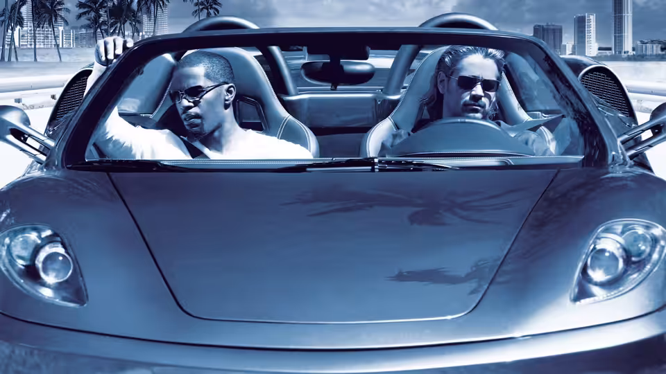 Rico Tubbs (Jamie Foxx) and Sonny Crockett (Colin Farrell) ride in a convertible through Miami