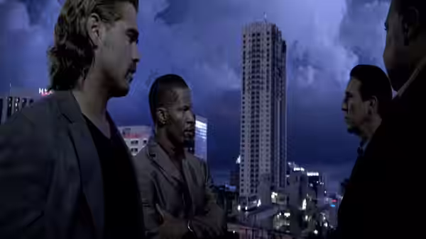 Sonny Crockett (Colin Farrell) and Rico Tubbs (Jamie Foxx) meet two men above the city at night