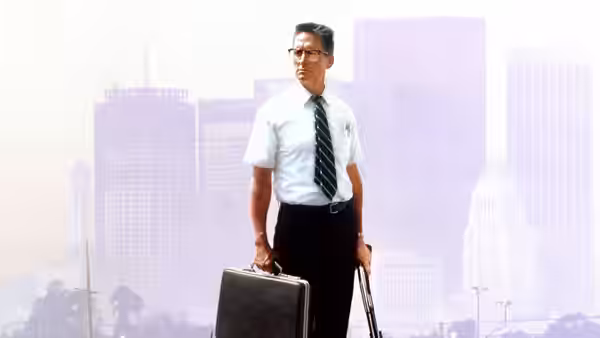 D-Fens (Michael Douglas) standing with briefcase and cane before hazy skyline