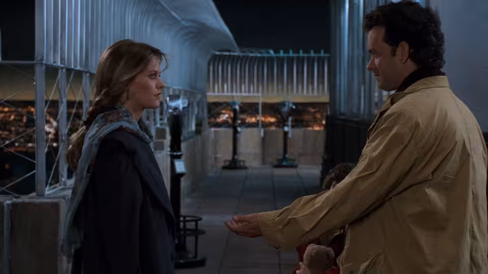 Annie Reed (Meg Ryan) faces Sam Baldwin (Tom Hanks) on a nighttime rooftop