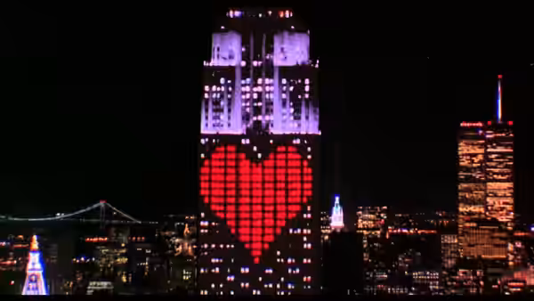 Empire State Building displays a large red heart made of lights at night