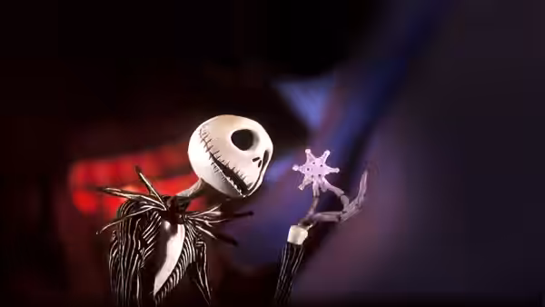 Jack Skellington holding a glowing snowflake on a dark night