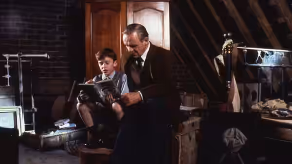 C. S. Lewis (Anthony Hopkins) reading with a boy in an attic
