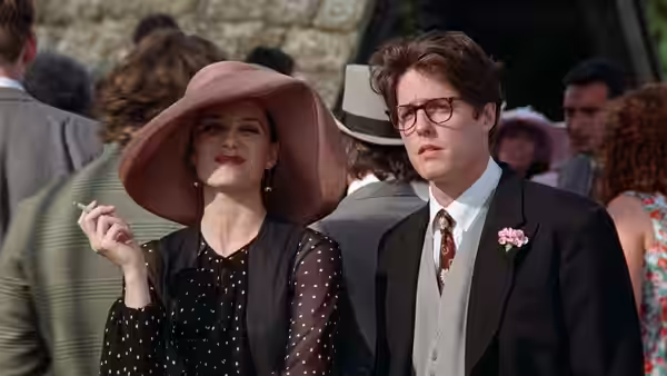Fiona (Kristin Scott Thomas) and Charles (Hugh Grant) stand among formally dressed guests