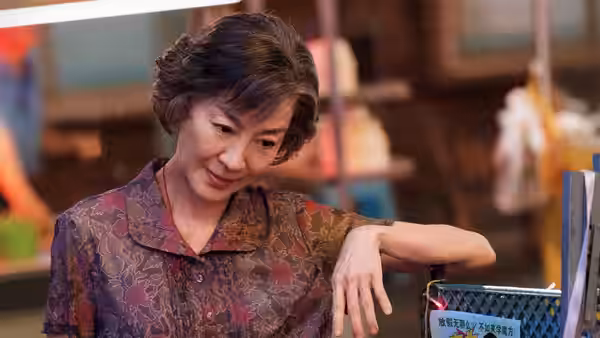 Zhao Yanhong (Michelle Yeoh) leans on a basket in a shop