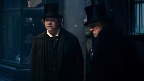 Bob Cratchit (Rupert Grint) and Ebenezer Scrooge (Johnny Depp) stand together on a shadowy street