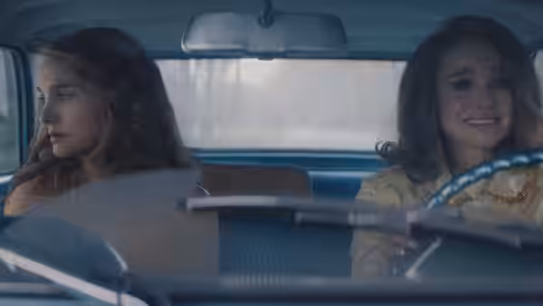 Maddie Schwartz (Natalie Portman) drives a car while a young woman sits beside her