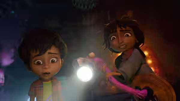 Two children peer into a dark room, one shining a flashlight