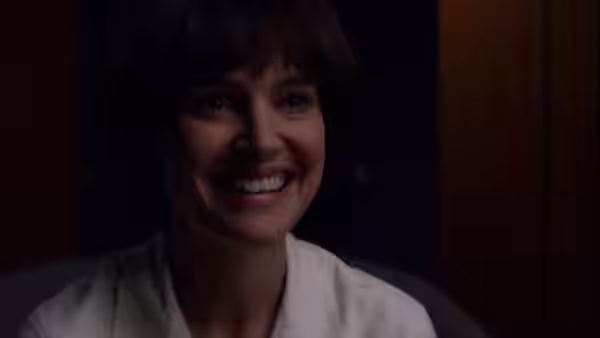 Lucy Cola (Natalie Portman) smiles in a white robe indoors