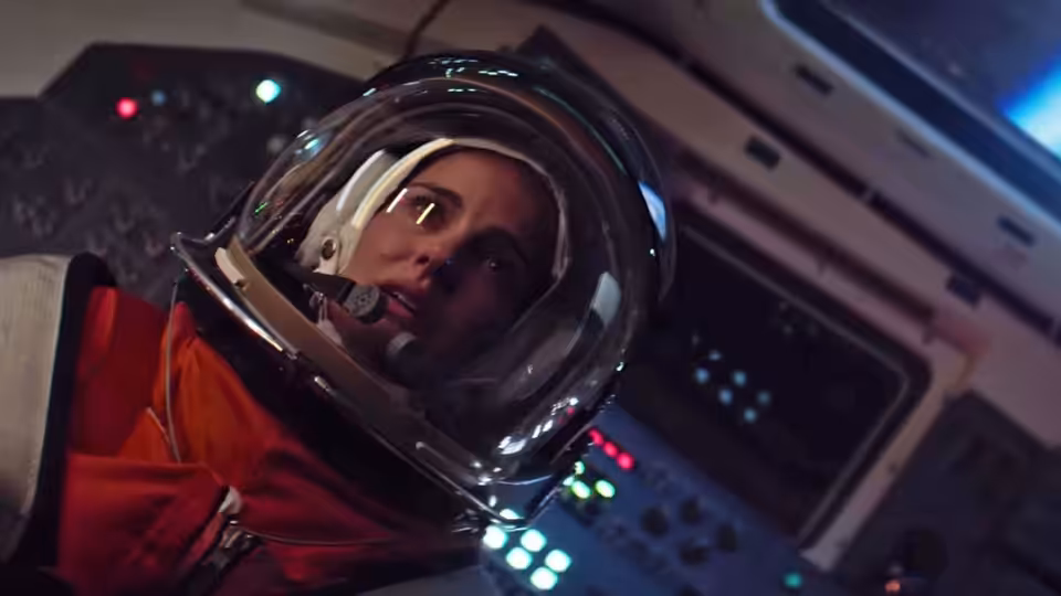 Lucy Cola (Natalie Portman) wears an astronaut suit inside a spacecraft