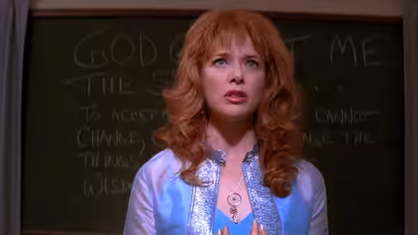Barbara Land (Annette Bening) stands before a chalkboard