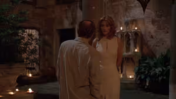 Von Sidell (Julia Roberts) faces Joe Berlin (Woody Allen) in a candlelit courtyard