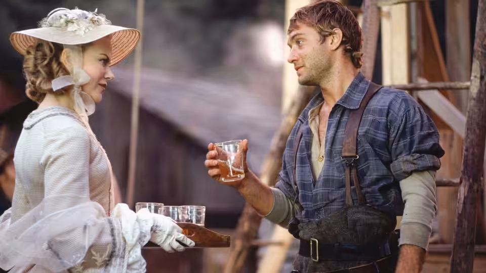 Ada Monroe (Nicole Kidman) offers a tray as Inman (Jude Law) holds a glass