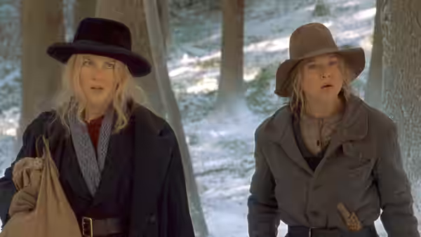 Ruby Thewes (Renée Zellweger) and Ada Monroe (Nicole Kidman) walk through snowy woods