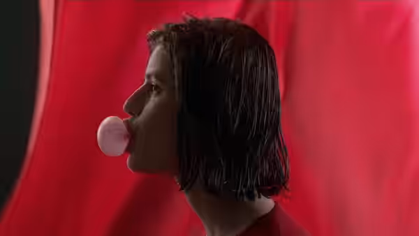 Valentine (Irène Jacob) blowing a large pink bubble of gum against a red backdrop