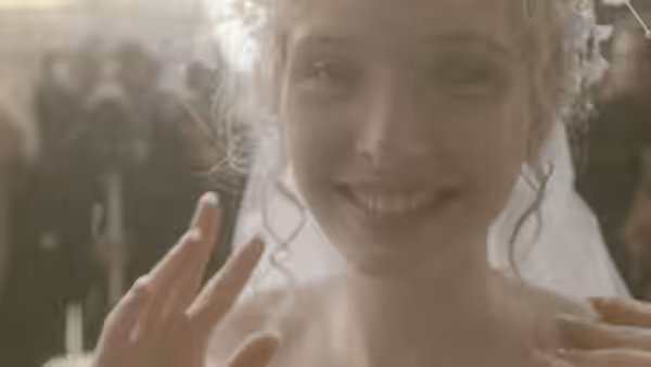 Dominique (Julie Delpy) smiling in wedding veil and dress