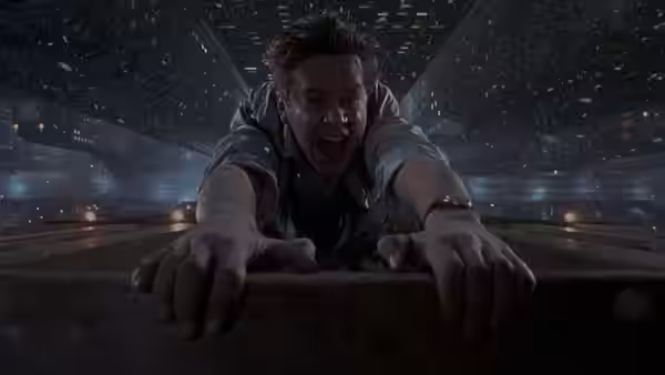 Norville Barnes (Tim Robbins) hanging from a high ledge above city lights