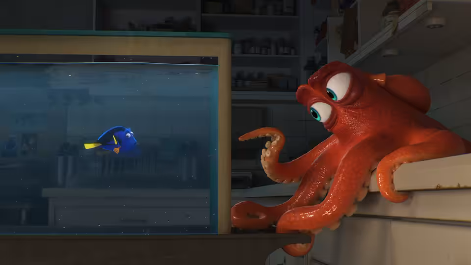 Hank the octopus watches Dory swimming inside a glass tank