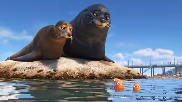 Marlin and Nemo swim below two sea lions on a rocky outcrop
