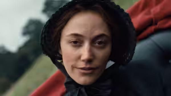 A bonneted woman looks ahead outdoors, with red fabric draped behind her