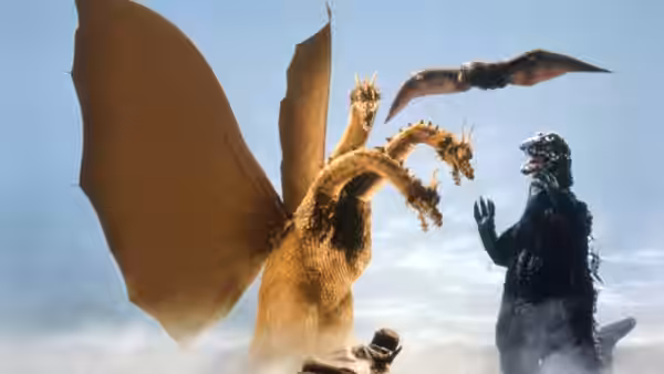 Godzilla confronts King Ghidorah while Rodan flies overhead