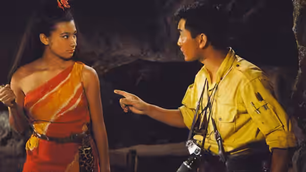 Saeko Matsumiya (Bibari Maeda) watches Goro Maki (Akira Kubo) point inside a cave