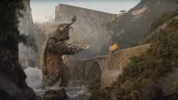 Megalon stands in a rocky ravine beside a stone bridge as debris falls