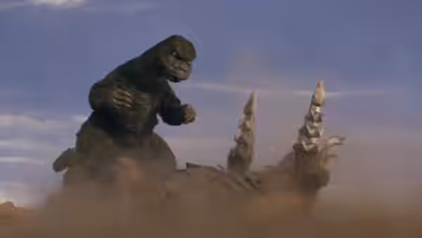Godzilla charges Megalon through a cloud of dust