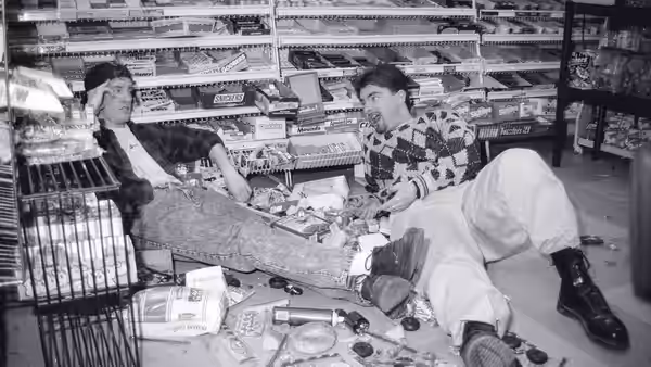 Dante (Brian O'Halloran) and Randal (Jeff Anderson) reclining on the floor of a convenience store amid scattered items