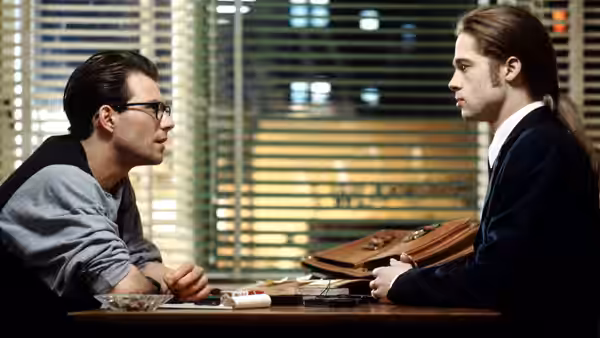 Malloy (Christian Slater) facing Louis (Brad Pitt) across a table