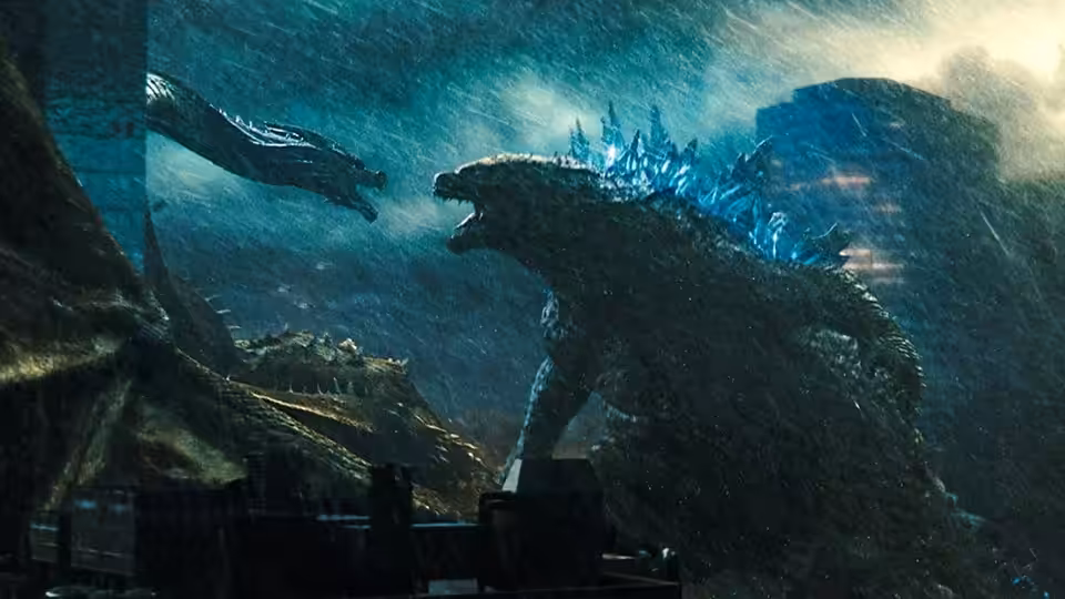 Two enormous monsters confront each other above a rain-soaked city