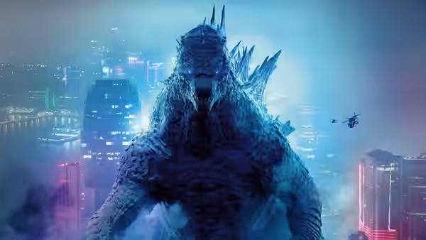 Godzilla towers over a city as helicopters fly nearby