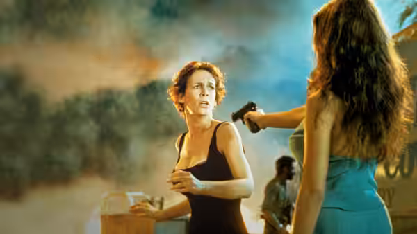 Helen (Jamie Lee Curtis) facing a woman pointing a gun
