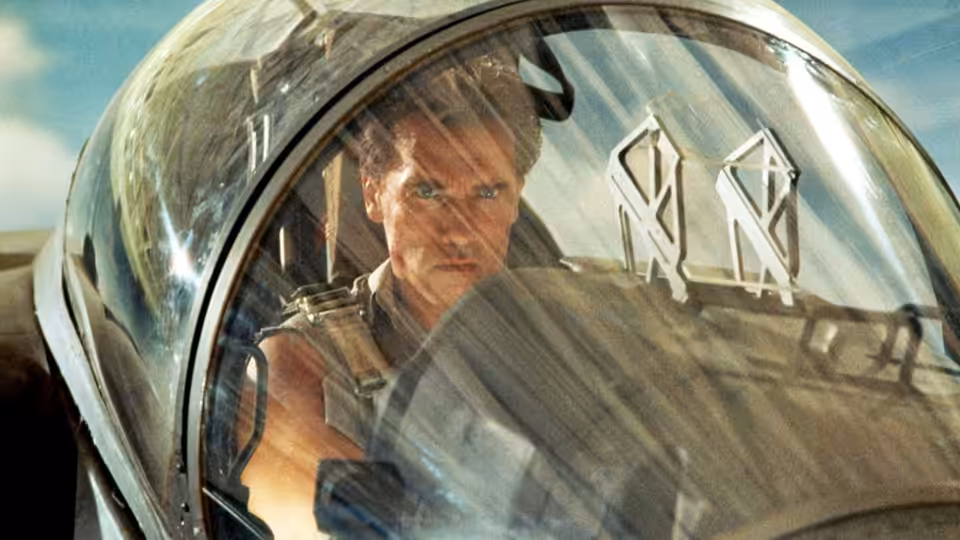 Harry (Arnold Schwarzenegger) piloting a fighter jet from the cockpit