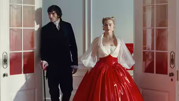 Heathcliff (Jacob Elordi) and Cathy (Margot Robbie) stand between open doors