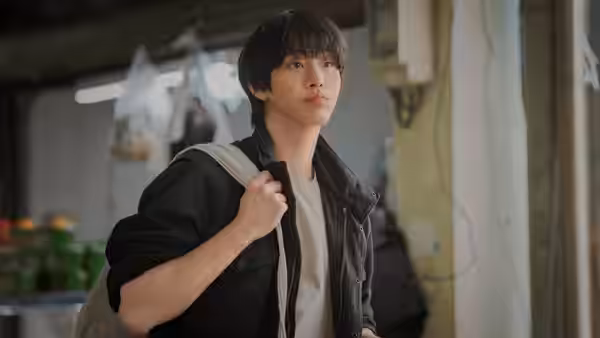 Kang-han (Ahn Hyo-seop) enters a room carrying a backpack over one shoulder