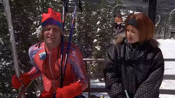 Harry Dunne (Jeff Daniels) in red ski suit on a ski lift with a woman