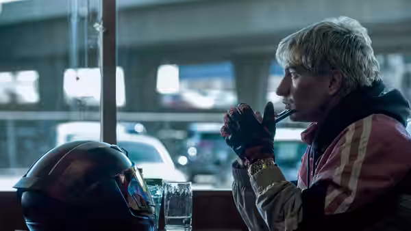 Barry Keoghan as Ormon drinks from a straw in a diner