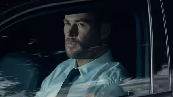 Chris Hemsworth as Davis drives a car at night