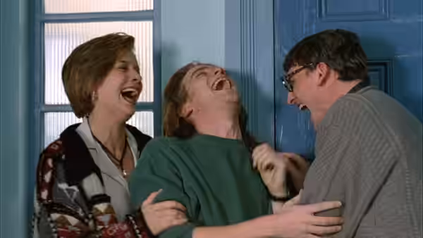 Juliet Miller (Kerry Fox), Alex Law (Ewan McGregor) and David Stephens (Christopher Eccleston) laugh together by a blue door