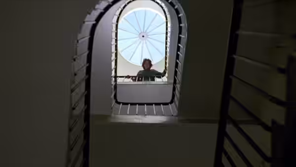 David Stephens (Christopher Eccleston) looks out through an arched window from inside