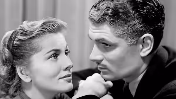 Mrs. de Winter (Joan Fontaine) gazing at Maxim de Winter (Laurence Olivier)
