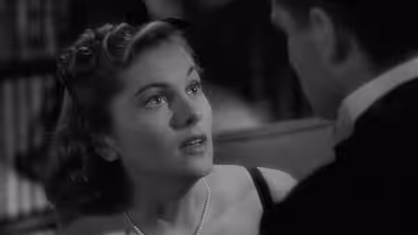 Mrs. de Winter (Joan Fontaine) looking up at a man with concern