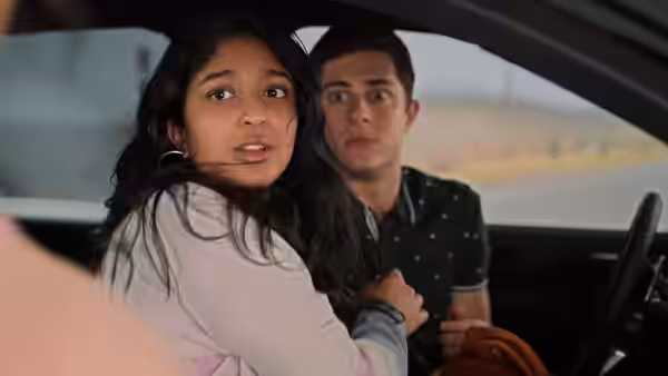 Devi and Ben look startled inside a car