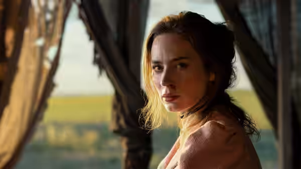Lady Cornelia Locke (Emily Blunt) looks back from inside a curtained wagon